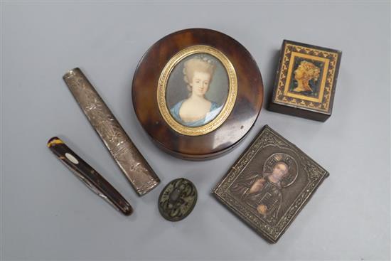 A circular tortoiseshell box, cover inset with portrait miniature, a miniature white metal icon and four other items